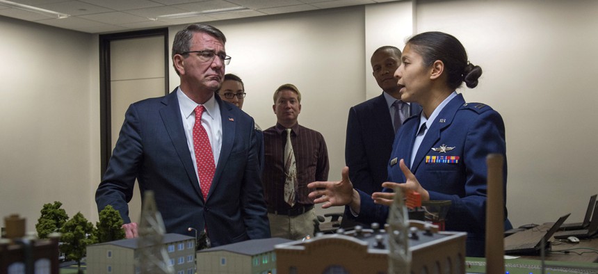 Secretary of Defense Ash Carter is briefed on some of the curriculum taught at the Air Force Academy as he tours the campus in Colorado Springs, Colo., May 12, 2016. 