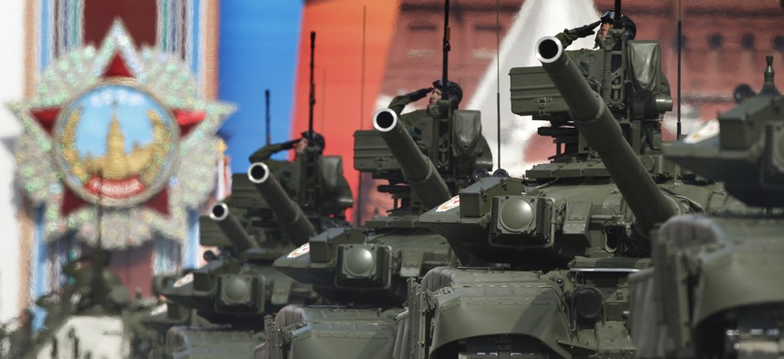 Russian tanks T-90 drive through the Red Square during the Victory Day Parade, which commemorates the 1945 defeat of Nazi Germany in Moscow, Russia, Monday, May 9, 2011, with a display depicting the Order of the Victory in the background.