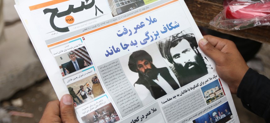 An Afghan local newspaper with photos of then-new leader of the Afghan Taliban, Mullah Akhtar Mansoor, center, and former leader Mullah Mohammad Omar, from Aug. 1, 2015.