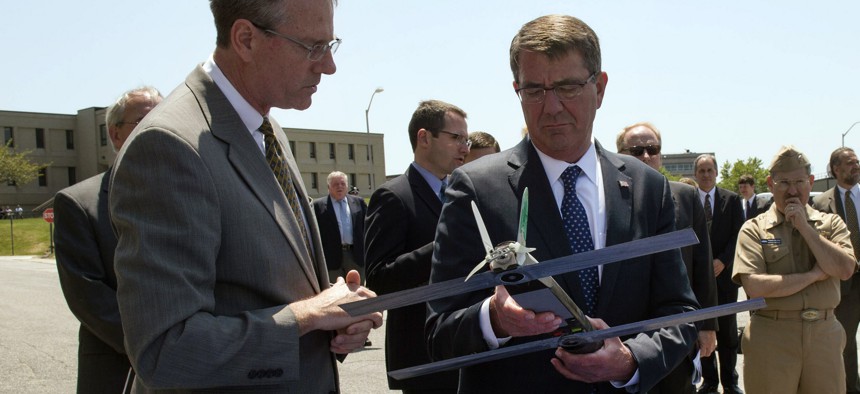Secretary of Defense Ash Carter examines an unmanned aerial vehicle during a visit to the Naval Undersea Warfare Center Newport in Newport, R.I., May 25, 2016