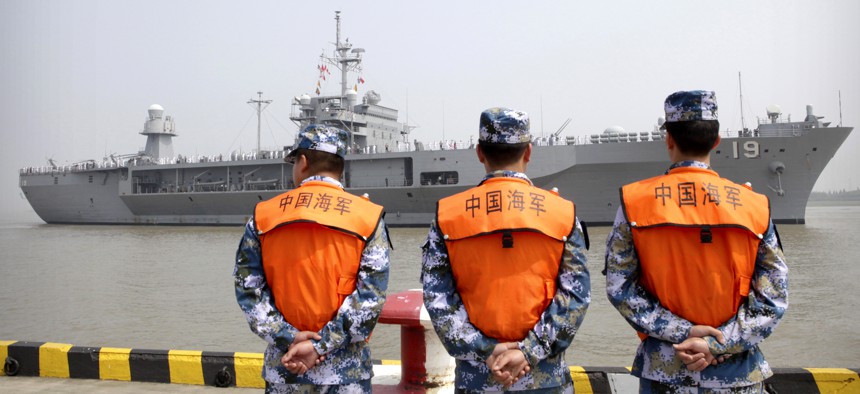 In May, U.S. and Chinese generals agreed to work toward rules to avoid confrontation in the South China Sea. Pictured, People's Liberation Army (PLA) Navy sailors watch the USS Blue Ridge arrive in Shanghai, May 6, 2016. 