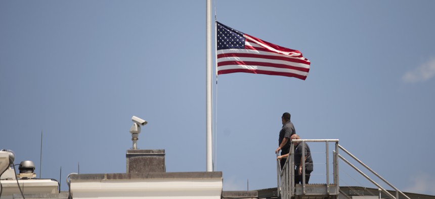 The American flag is flown at half staff over the White House in Washington, Sunday, June 12, 2016, after President Barack Obama spoke about the massacre at an Orlando nightclub.