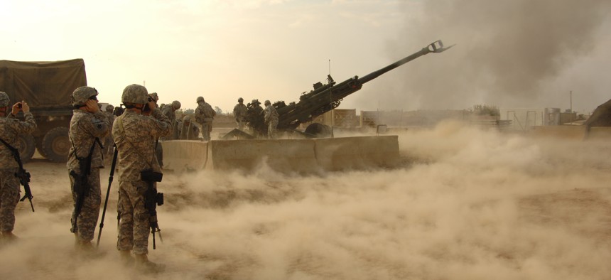 U.S. troops fire rounds to calibrate an M777 howitzer on Forward Operating Base Warhorse, Iraq, Dec. 8, 2009.