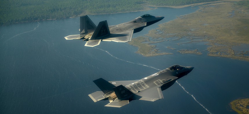 An Air Force F-22 Raptor (left) flies with an F-35 Joint Strike Fighter over Florida.