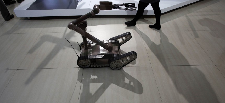 A remote controlled robot cast a shadow at an exhibition on police equipment and anti-terror technologies held in Beijing, China, Thursday, May 19, 2011.