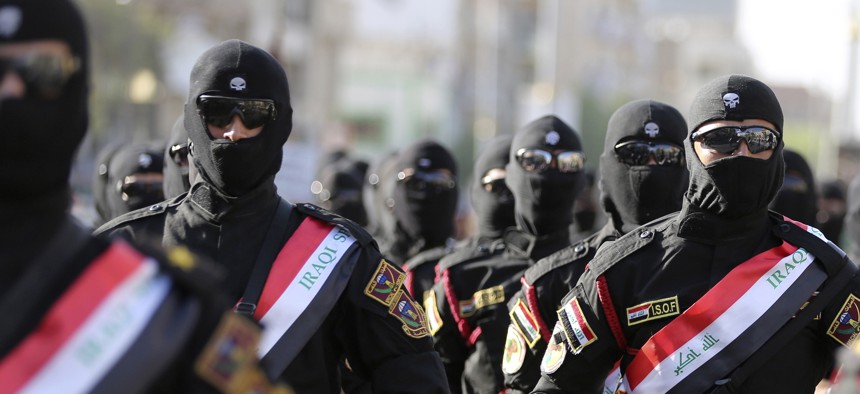 Iraqi security force members parade in Baghdad, Iraq, Thursday, July 14, 2016. 