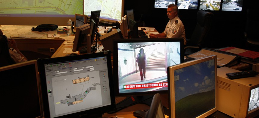 French Police officer checks on video monitors and computer screens in the underground security central command center of the Paris prefecture, in Paris, Wednesday Sept. 22, 2010.