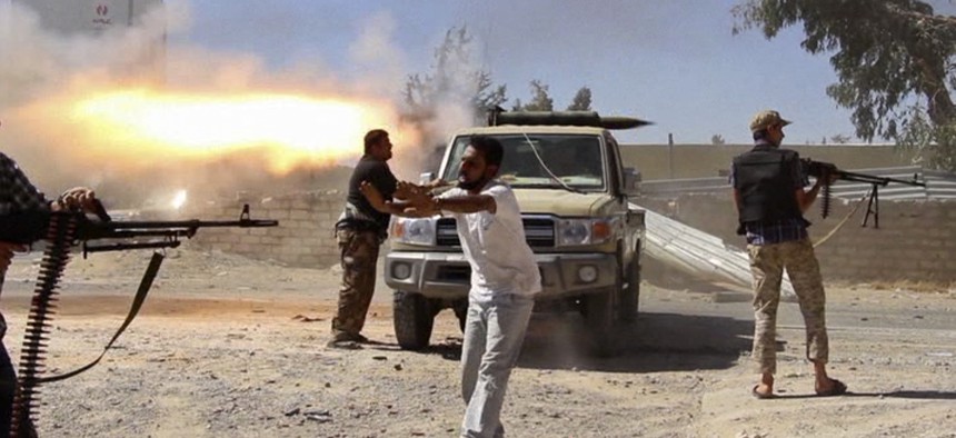 Fighters from the Islamist Misarata brigade fire towards Tripoli airport in an attempt to wrest control from a powerful rival militia, in Tripoli, Libya, July 26, 2014.
