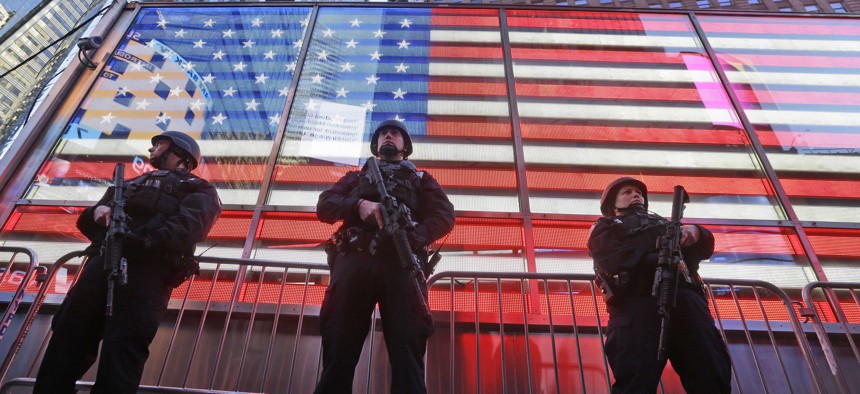In this Nov. 14, 2015 file photo, heavily armed New York city police officers with the Strategic Response Group stand guard at the armed forces recruiting center in New York's Times Square. 