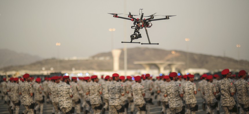 In this Thursday, Sept. 17, 2015 file photo, a drone is used to record a military parade by Saudi security forces in preparation for the annual Hajj pilgrimage in Mecca, Saudi Arabia.