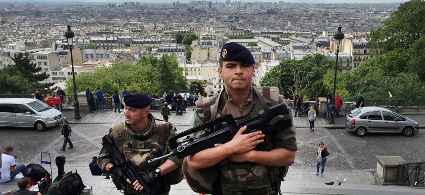 French army soldiers walk up the stairs to Sacre Coeur basilica in Paris, France, Thursday June, 16, 2016. 