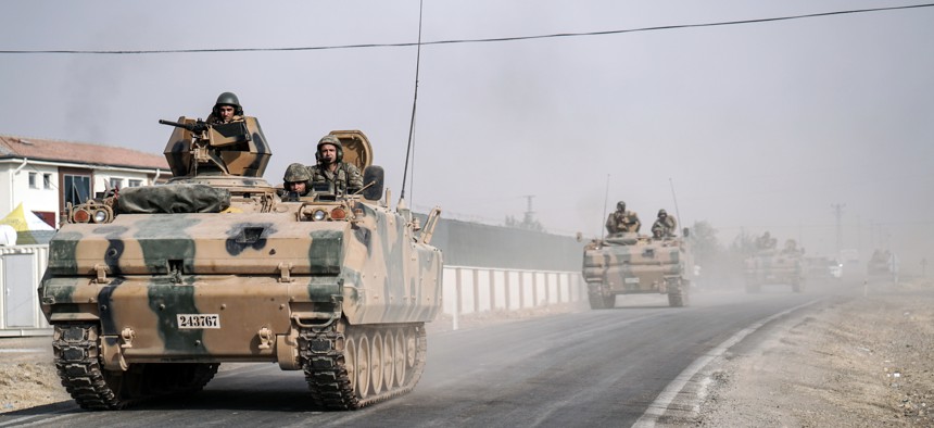 Turkish army tanks and armored personnel carriers move toward the Syrian border, in Karkamis, Turkey, Thursday, Aug. 25, 2016.