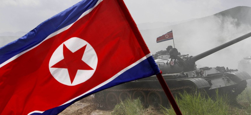 A North Korean flag flutters during a military exercise by the historic 105 tank unit at an undisclosed location in North Korea Friday, July 27, 2012.