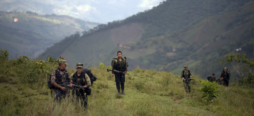 Members of the 36th Front of the Revolutionary Armed Forces of Colombia or FARC, trek to a new camp in Antioquia state, in the northwest Andes of Colombia, Jan. 3, 2016.