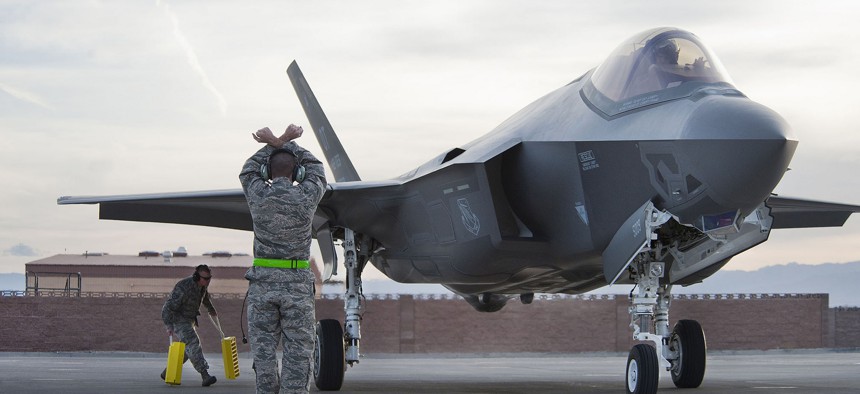 Crew chiefs from the 57th Wing Lightning Aircraft Maintenance Unit marshal an F-35 Lighting II, March 6, 2013, at Nellis Air Force Base, Nev.