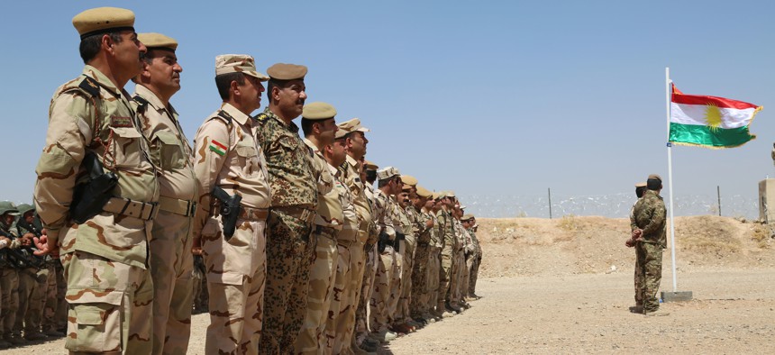 Peshmerga troops stand in formation during the Modern Brigade Course 2 graduation ceremony at the Menila Training Center, Iraq, July 28, 2016.