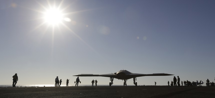 The Navy experimental unmanned aircraft, the X-47B, taxies to it's launch position on the flight deck aboard the nuclear powered aircraft carrier USS Theodore Roosevelt, off the Virginia coast, Sunday, Nov. 10, 2013.