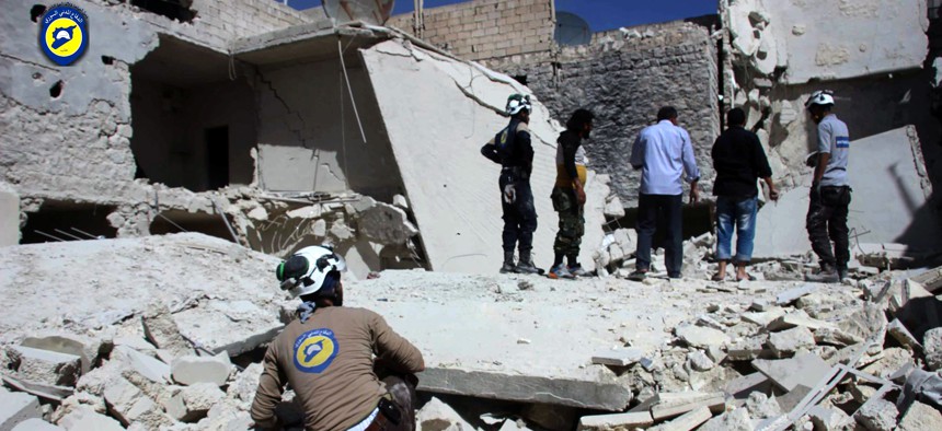 Members of Civil Defense inspecting damaged buildings after airstrikes hit the Bustan al-Qasr neighborhood of Aleppo, Syria, Sunday, Sept. 25, 2016.
