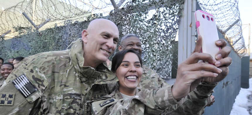 U.S. Army Staff Sgt. Austina Knotek takes a photo with the United States Army Chief of Staff, Gen. Ray Odierno in Kabul, Afghanistan, February 7, 2014.