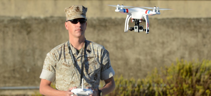 A U.S. Marine uses a commercial-grade Quadcopter to capture aerial video footage of the USNS William R. Button on the pier in Rota, Spain, during the preparation phase of Trident Juncture 2015.
