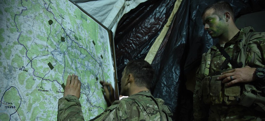 U.S. soldiers track unit movements on a map during Exercise Allied Spirit V at the 7th Army Training Command's Hohenfels Training Area, Germany, Oct. 8, 2016. 