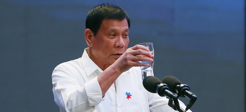 Philippine President Rodrigo Duterte makes a toast during his address to a Filipino business sector in suburban Pasay city south of Manila, Philippines Thursday, Oct. 13, 2016.