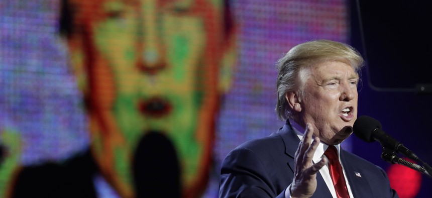 Republican presidential candidate Donald Trump is seen on a large screen as he speaks during a charity event hosted by the Republican Hindu Coalition, Saturday, Oct. 15, 2016, in Edison, N.J.