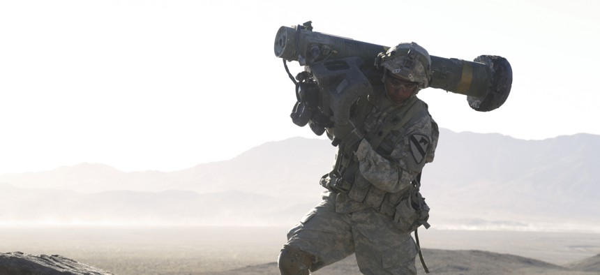 A U.S. Soldier assigned to 1st Battalion, 12th Cavalry Regiment, 3rd Brigade Combat Team, 1st Cavalry Division, carries a Javelin shoulder-fired anti-tank missile during Decisive Action Rotation 17-01 at the National Training Center in Fort Irwin, Calif.,