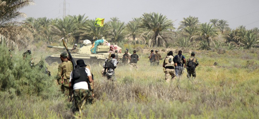 Iraqi security forces backed by allied Shiite Popular Mobilization forces and Sunni tribal fighters prepare to attack Islamic State positions at Khalidiya Island in Anbar province, Iraq, Monday, Aug. 1, 2016.