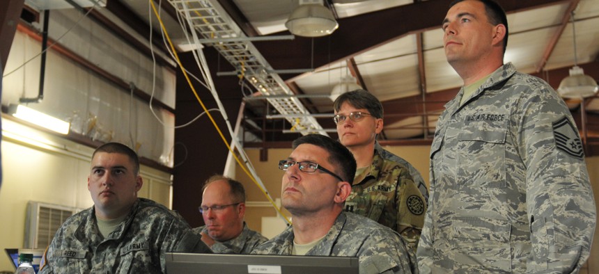 National Guard soldiers and airmen of the Blue Team listen to their team leader Cyber Shield 2016 at Camp Atterbury, Ind. April 20, 2016.