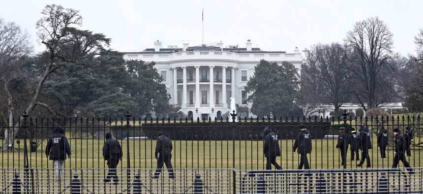 Secret Service officers search the south grounds of the White House in Washington, Monday, Jan. 26, 2015. 