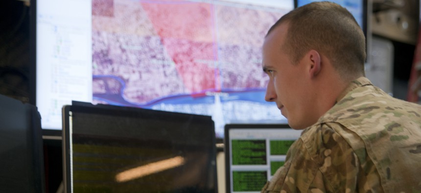 A U.S. Army officer watches his monitor for updates from clearance operations in Ramadi, Iraq from the Combined Joint Operations Command (CJOC) in Baghdad, Iraq Dec. 30, 2015.