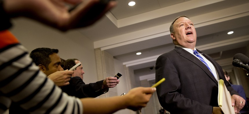 Reporters hold out recorders as House Benghazi Committee member Rep. Mike Pompeo, R-Kansas, speaks to the media on Capitol Hill in Washington, Friday, Oct. 16, 2015.