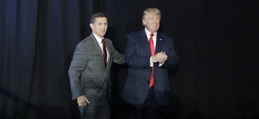 Retired Gen. Michael Flynn, left, introduces then-Republican presidential candidate Donald Trump at a campaign rally, Thursday, Sept. 29, 2016, in Bedford, N.H.