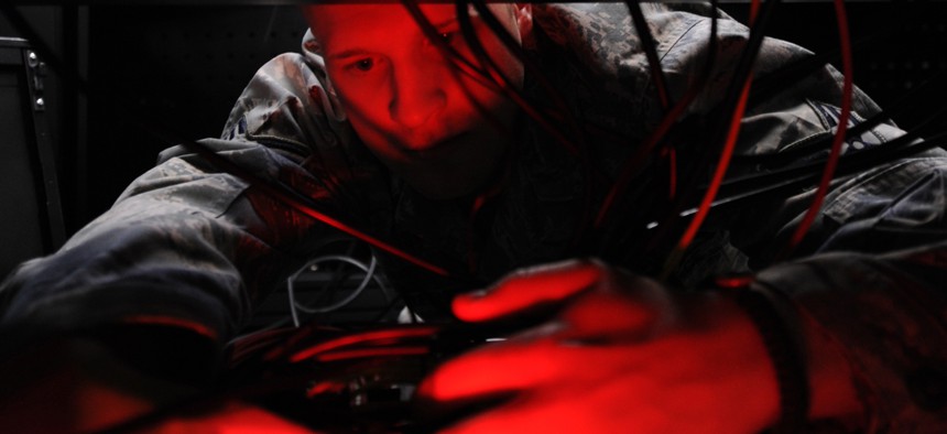 An Airman installs computer systems on the operations floor of the new 497th Intelligence, Surveillance, and Reconnaissance Group building at Langley Air Force Base, Va., April 21, 2010.