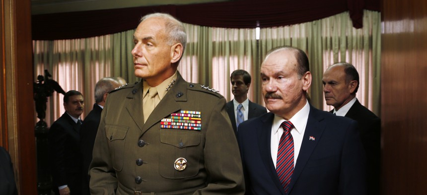 U.S. Marine Gen. John F. Kelly, commander of U.S. Southern Command, arrives for a press conference accompanied by Paraguay's Defense Minister Gen. Bernardino Soto, in Asuncion, Paraguay, Wednesday, July 30, 2014. 