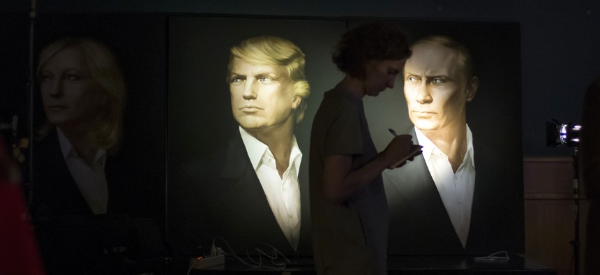 A woman passes by portraits of U.S. presidential candidate Donald Trump and Russian President Vladimir Putin in the Union Jack pub in Moscow, Russia, Wednesday, Nov. 9, 2016.