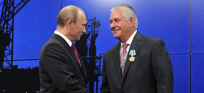 Russian President Vladimir Putin presents ExxonMobil CEO Rex Tillerson with a Russian medal at an award ceremony of heads and employees of energy companies at the St. Petersburg economic forum in St. Petersburg, Russia, June 21, 2012.