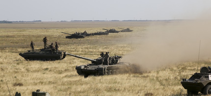 Ukrainian tanks and APCs move towards the de-facto border with Crimea near Kherson, southern Ukraine, Friday, Aug. 12, 2016. 