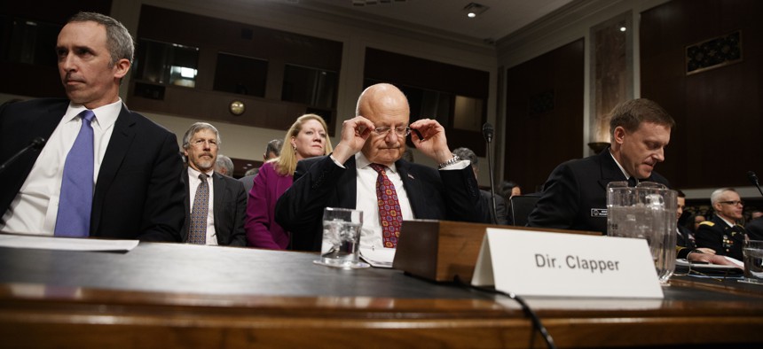 Director of National Intelligence James Clapper, center, Defense Undersecretary for Intelligence Marcel Lettre II, left, and National Security Agency and Cyber Command chief Adm. Michael Rogers prepare to testify on Capitol Hill, Jan. 5, 2016.