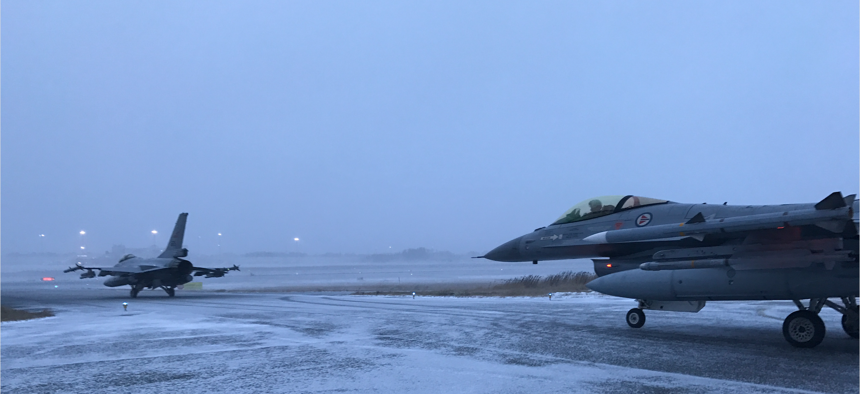 Two Norwegian Air Force jets taxi onto the runway at Bodø, Norway, in a demonstration of their ability to get airborne in less than 15 minutes.