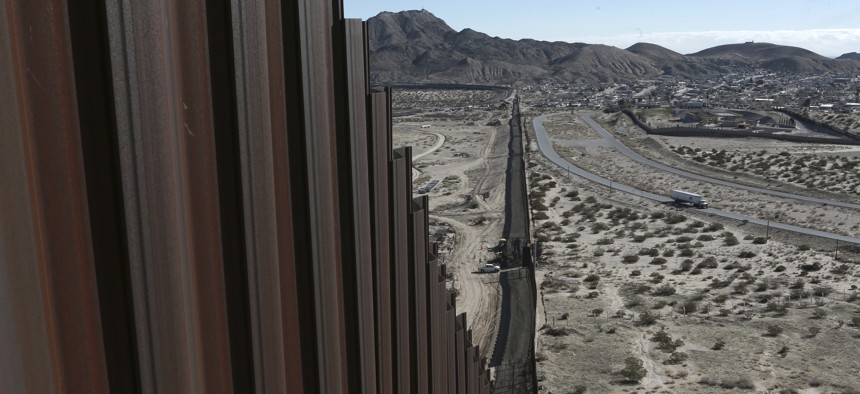 A truck drives near the Mexico-US border fence, on the Mexican side, separating the towns of Anapra, Mexico and Sunland Park, New Mexico, Wednesday, Jan. 25, 2017