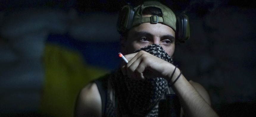 In this photo taken on Friday, Aug. 26, 2016, a Ukrainian soldier smokes in the village of Marinka, near Donetsk, eastern Ukraine. More than 9,500 people have been killed in the fighting that began in April 2014, according to United Nations figures,