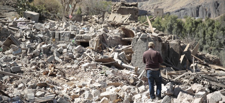 A man walks amid the rubble of a house destroyed by a Saudi-led airstrike on the outskirts of Sanaa, Yemen, Thursday, Feb. 2, 2017.