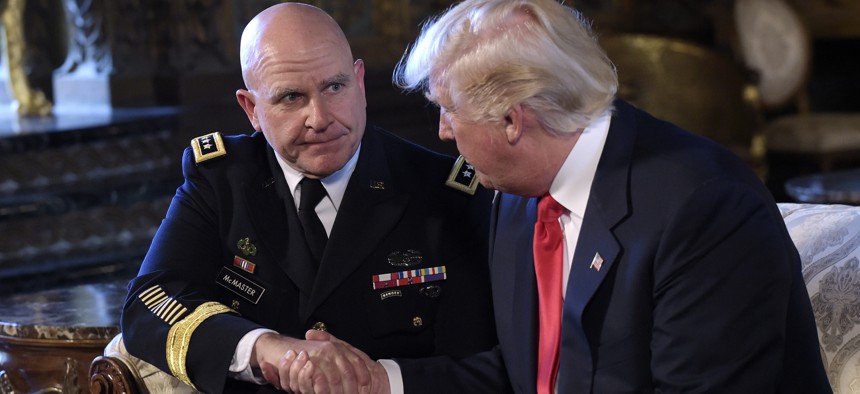 President Donald Trump, right, shakes hands with Army Lt. Gen. H.R. McMaster, left, at Trump's Mar-a-Lago estate in Palm Beach, Fla., Monday, Feb. 20, 2017, 