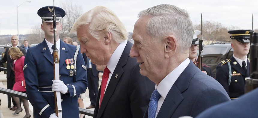 U.S. Defense Secretary Jim Mattis, right, and U.S. President Donald Trump walk into the Pentagon in Washington, Jan. 27, 2017. 