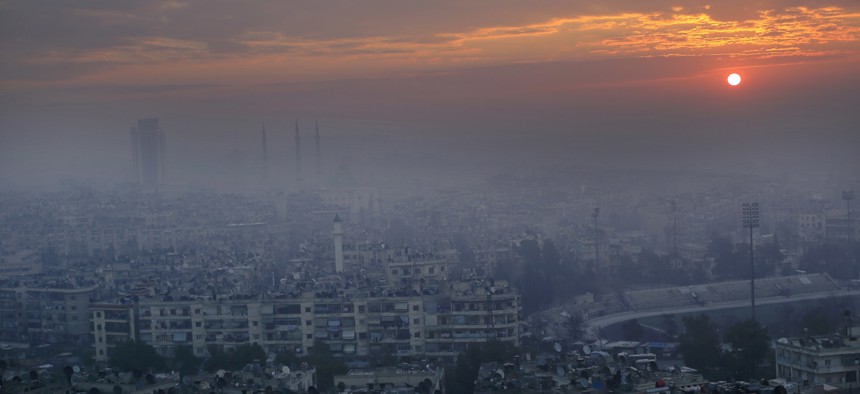 In this Jan. 20, 2017 file photo, the sun rises as blanket of fog covers the Aleppo citadel and the city of Aleppo, Syria.