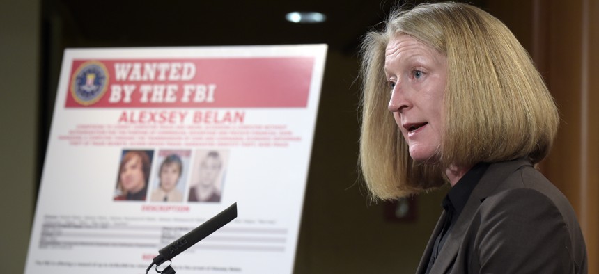 Acting Assistant Attorney General Mary McCord speaks during a news conference at the Justice Department in front of a mug shot poster of Russian hackerAlexsey Alexseyevich Belan.