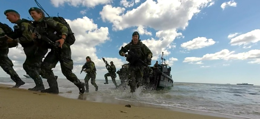 NATO Response Force and Allied Marines from the U.K., U.S., Sweden, and Finland simulate amphibious assaults on a Swedish beachhead during BALTOPS 2015.