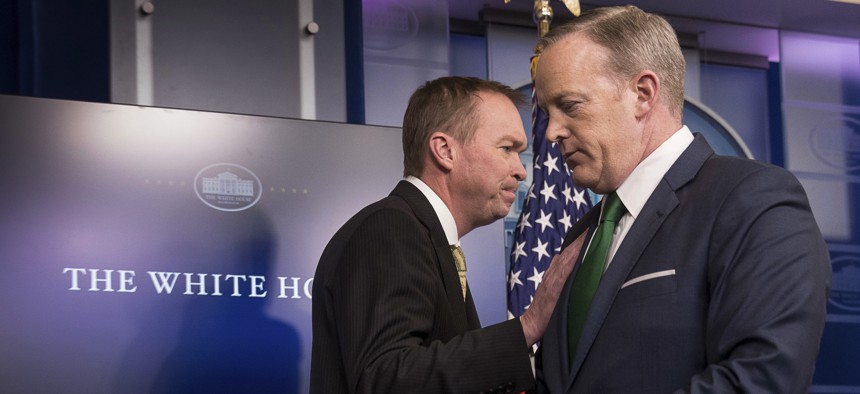 White House press secretary Sean Spicer, right, give the podium to Budget Director Mick Mulvaney during daily press briefing at the White House in Washington, Thursday, March 16, 2017, where he spoke about the Trump Administration's budget proposals. 
